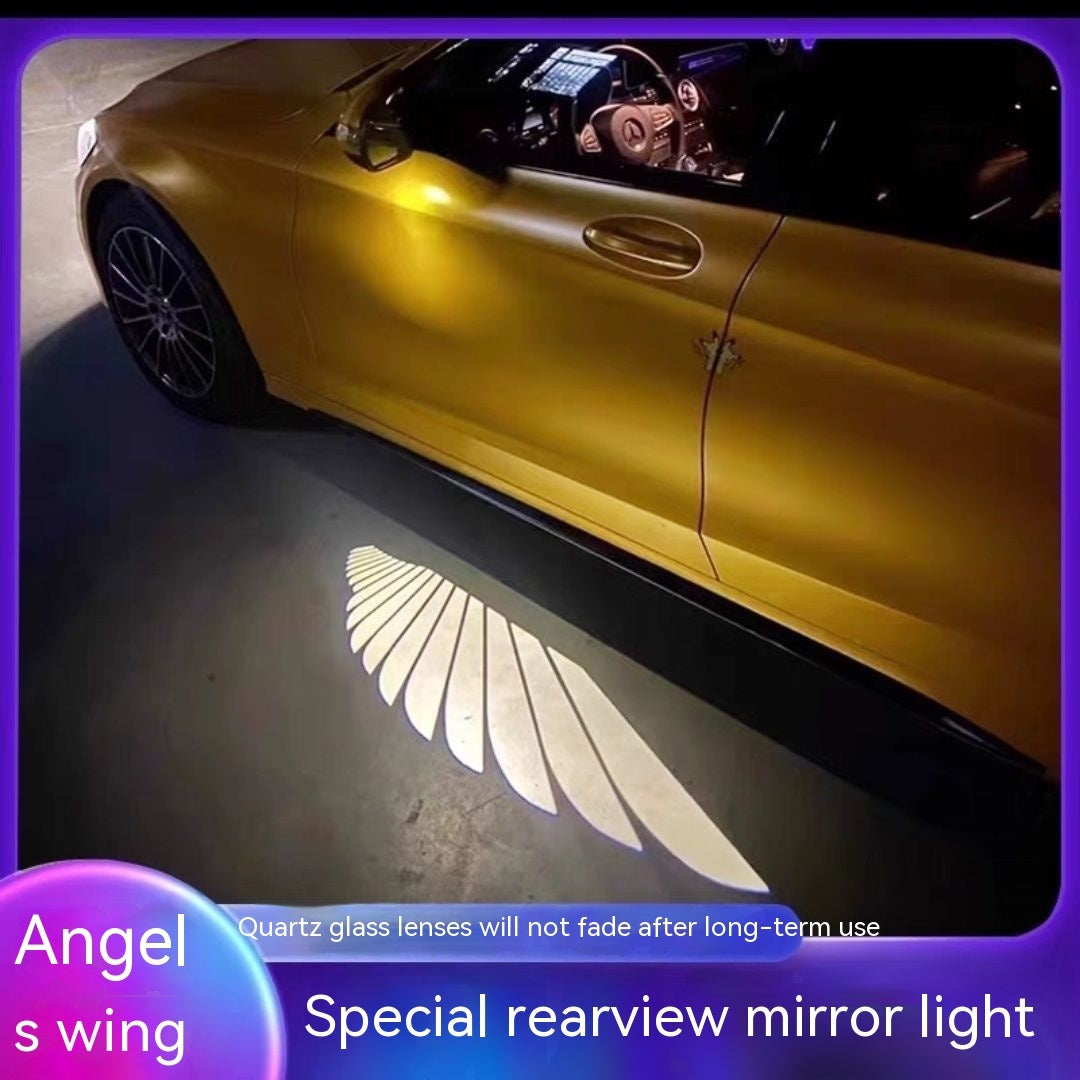 Car Rearview Mirror Angel Wings Lamp projecting a white angel wings light onto the ground near a luxury car.