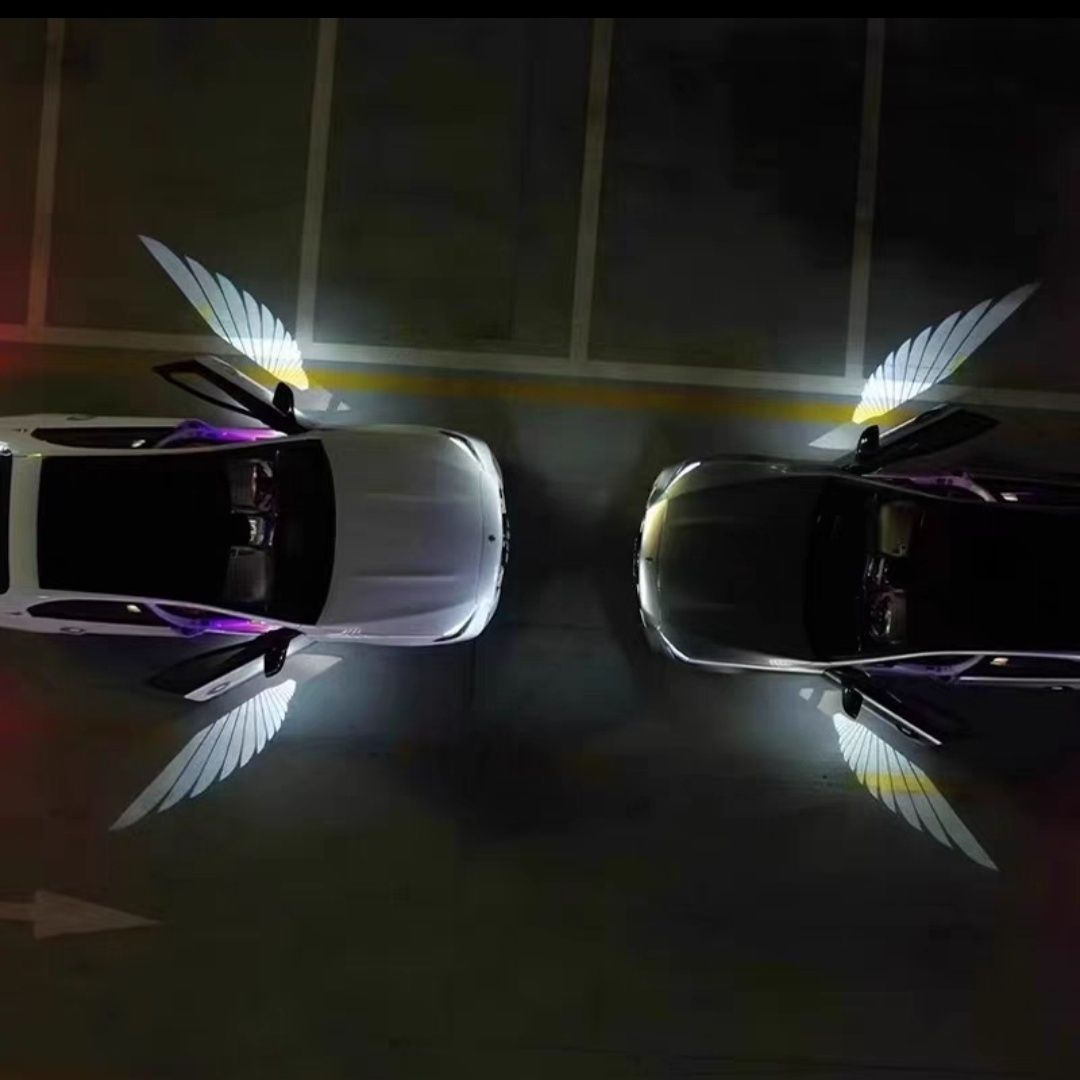 Car Rearview Mirror Angel Wings Lamp – LED Courtesy Light illuminating two cars in a parking lot.