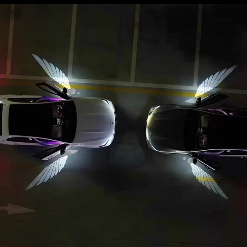 Car Rearview Mirror Angel Wings Lamp – LED Courtesy Light illuminating two cars in a parking lot.